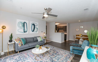 a living room with a couch and a ceiling fan