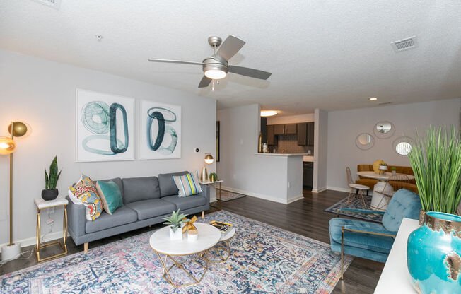 a living room with a couch and a ceiling fan