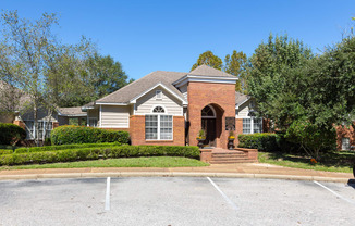 Leasing office exterior with parking at Lenox Gates in Mobile, AL