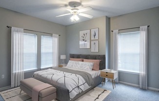 a bedroom with a bed and a ceiling fan