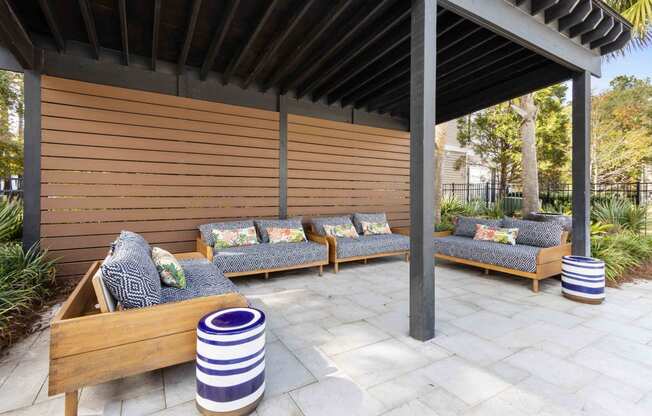 a covered patio with couches and a pergola