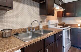 This is a photo of the kitchen of the 590 square foot 1 bedroom, 1 bath model apartment at The Biltmore Apartments located int he Vickery Meadow neighborhood of Dallas, TX.