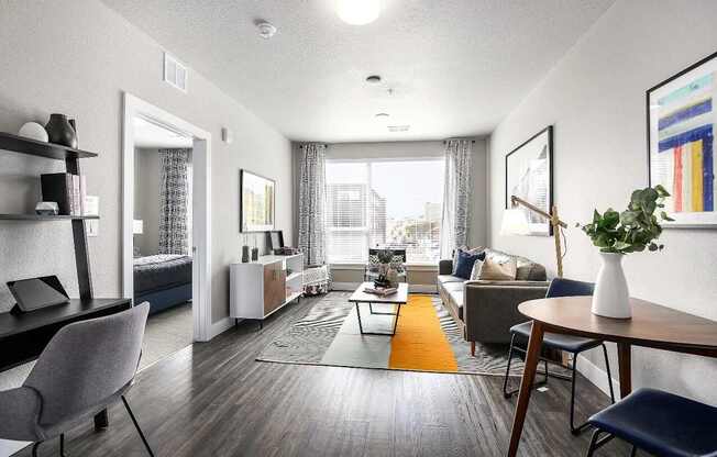 A living room with a grey chair and a brown table.