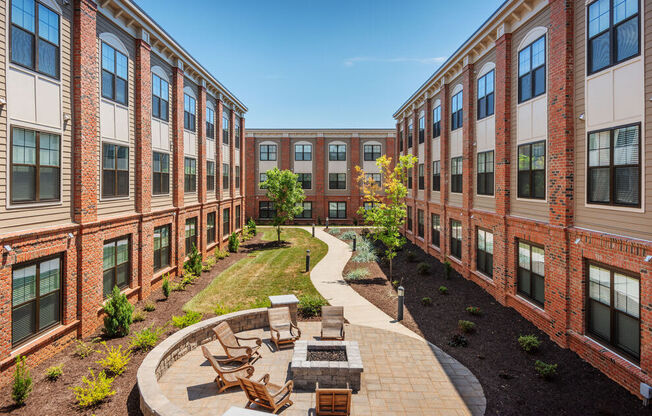 A courtyard surrounded by red brick buildings.