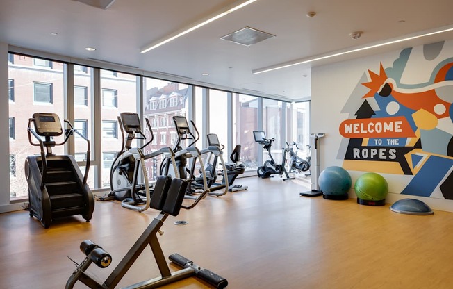 A gym with a sign that says "Welcome to the Ropes".