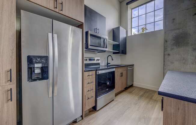 a kitchen with stainless steel appliances and wooden cabinets