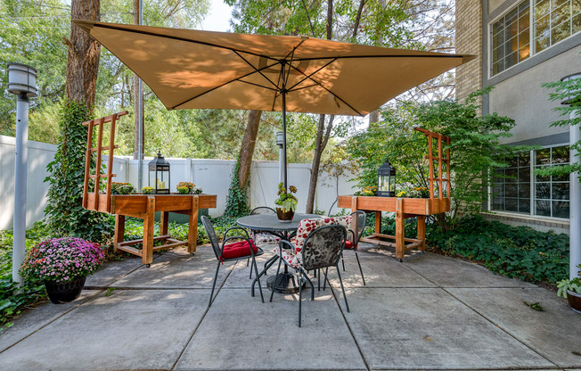 a patio with a table and chairs and a large umbrella