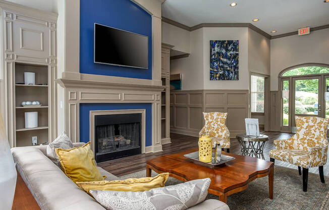 A living room with a fireplace and a television.