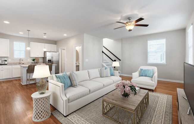 A living room with a white couch and a coffee table.