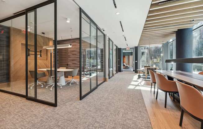 a conference room with glass walls and tables and chairs