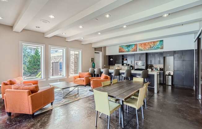 a living room with a table and chairs and a kitchen