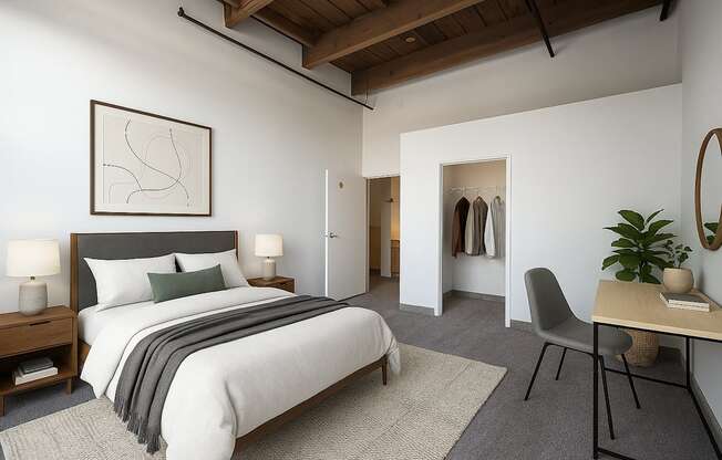 A bedroom with a large bed and a chair.