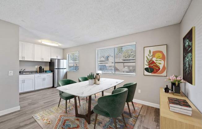 A dining room with a table and chairs.
