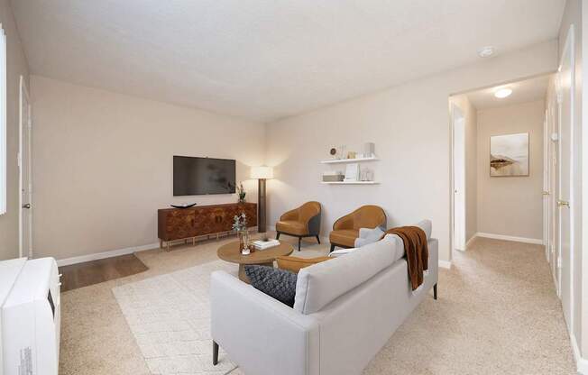 A living room with a white couch and a television.