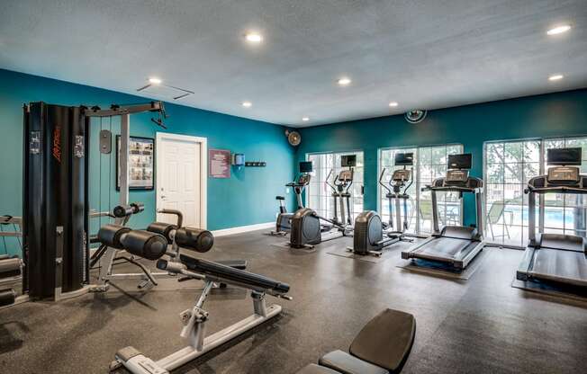 Apartment gym with exercise equipment and a large window