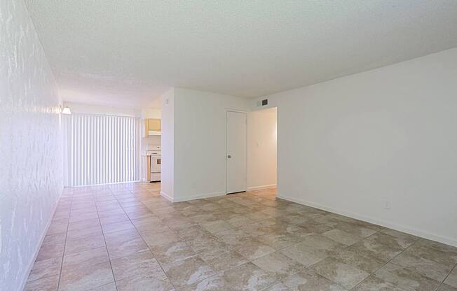 A room with a tiled floor and a white door.