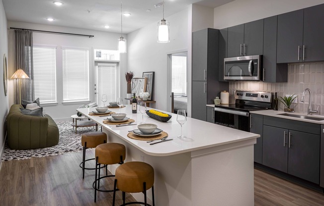 Discover ample space for meal prep and entertaining with the expansive chef’s kitchen island at Modera Garden Oaks.