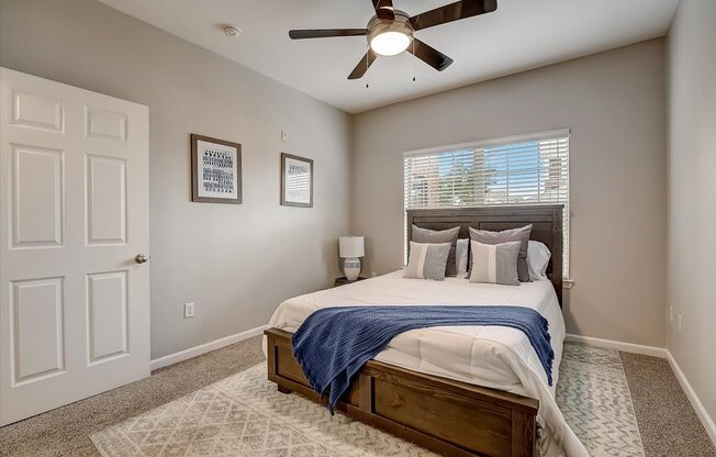 a bedroom with a large bed and a ceiling fan