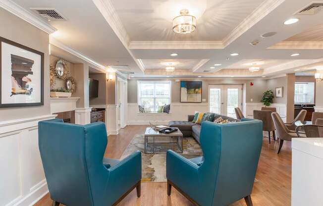 View of Resident Lounge with Dual Chair Seating Towards Outdoor Amenity Space | Canton Woods apartments in MA