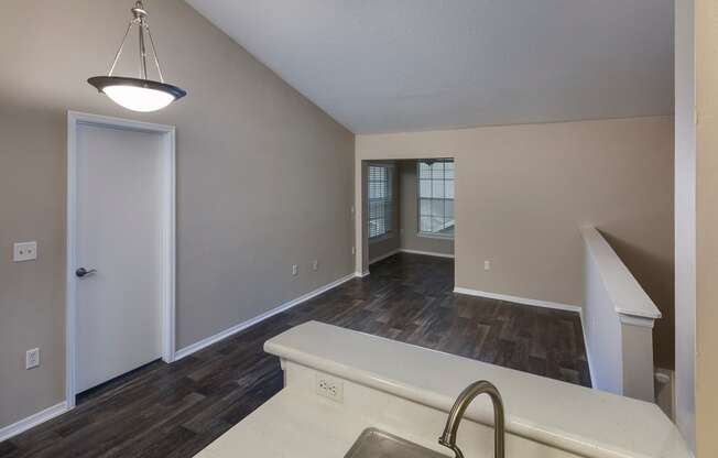 a view of a living room and a dining room with a window and a door