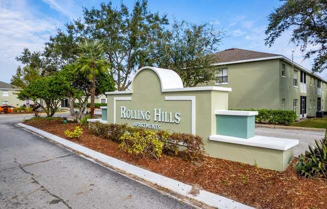 Rolling Hills Apartments sign in front of a building.