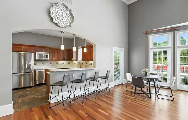 A kitchen with a dining table and chairs.