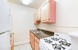 kitchen with gas range, sink and refrigerator at 4031 davis place apartments in washington dc