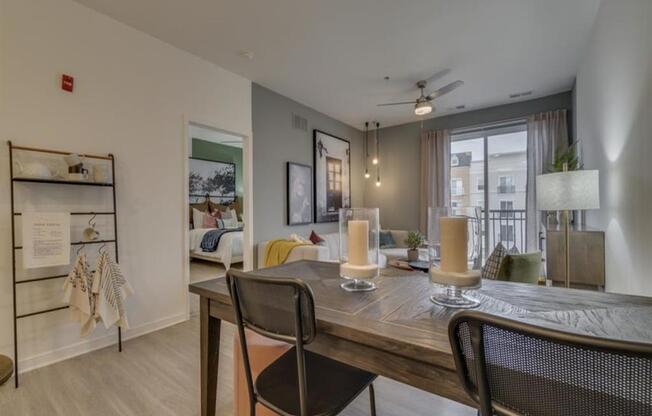 a dining area with a table and chairs and a couch in the background at Flats at West Broad Village, Glen Allen, VA 23060