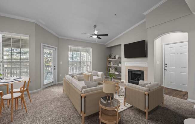 a living room with couches and chairs and a fireplace