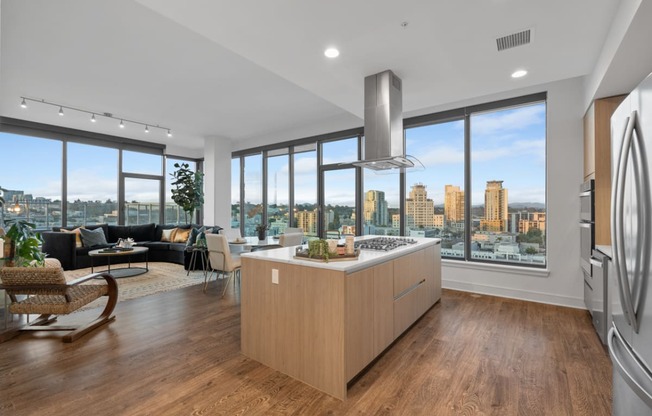 a kitchen with a large island next to a window with a city view at Stanza Little Italy, California, 92101