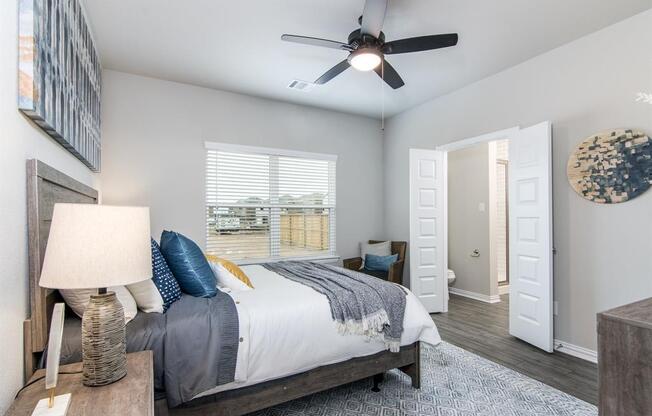 a bedroom with a bed and a ceiling fan