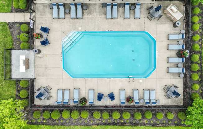 arial view of a swimming pool with lounge chairs