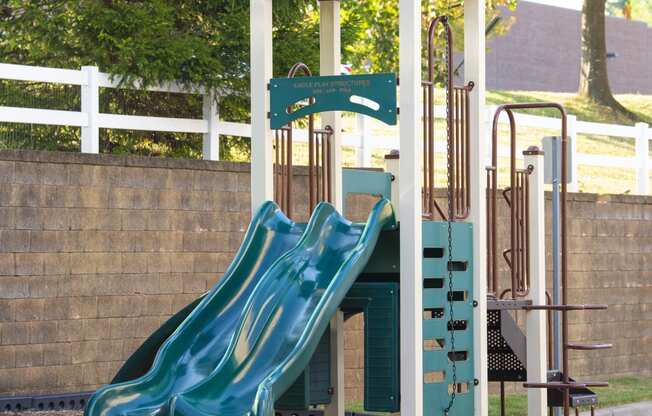 a playground with a slide and a swing set