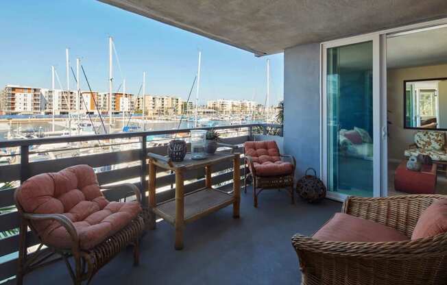 a balcony with a view of a harbor and a living room