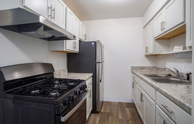 a kitchen with stainless steel appliances at Fairlane Apartments in Springfield, MI