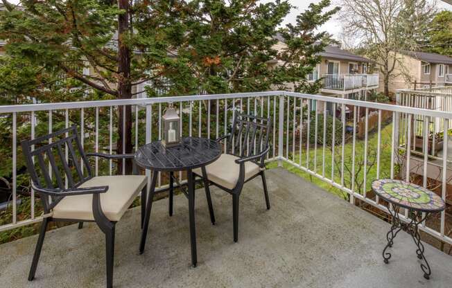 a patio with a table and chairs on a balcony