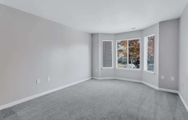 an empty living room with a large window