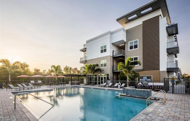 a swimming pool with a building in the background
