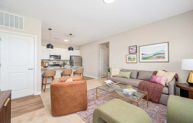 A living room with a grey couch and a coffee table.