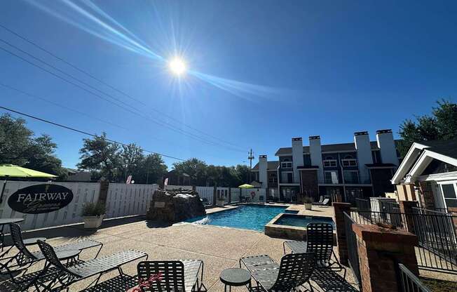 A sunny day at the Fairway pool area with chairs and tables arranged for relaxation.