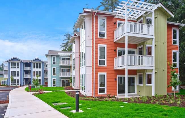 an apartment building with a sidewalk in front of it at Woodcreek, Poulsbo