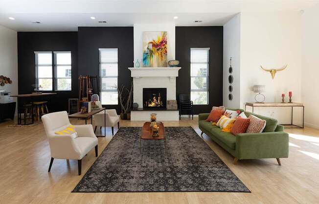 A living room with a fireplace and a green couch.