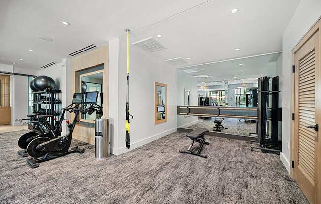 Bright fitness studio with TRX suspension, spin bikes, and mirrored walls perfect for versatile training