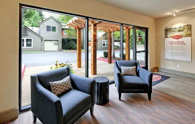 a living room with two chairs and a table