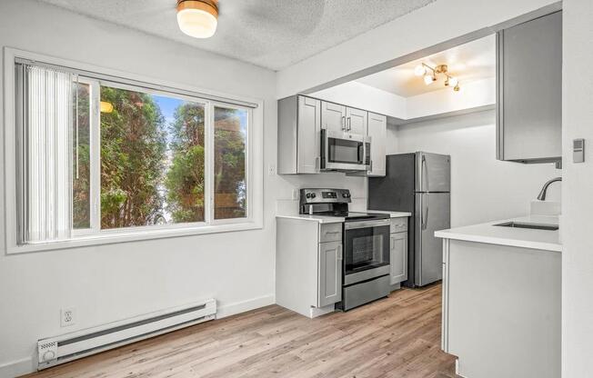 a kitchen with a stove top oven next to a window