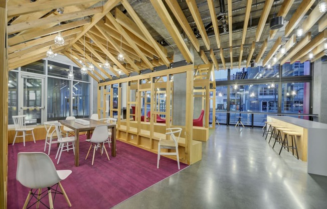 a dining room with tables and chairs and a building in the background at L Seven, San Francisco, California 94103