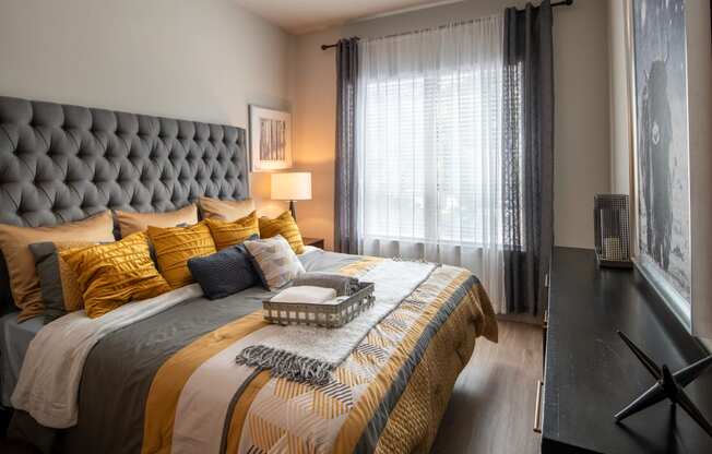 a bedroom with a large bed and a window