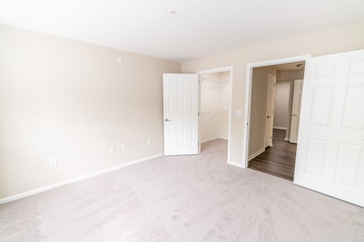 a bedroom with two closets and a door to a closet at Merion Milford Apartment Homes, Milford, CT