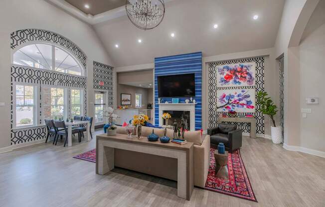 A living room with a fireplace and a large rug.