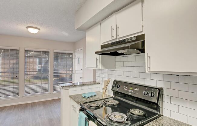 a stove top oven sitting inside of a kitchen